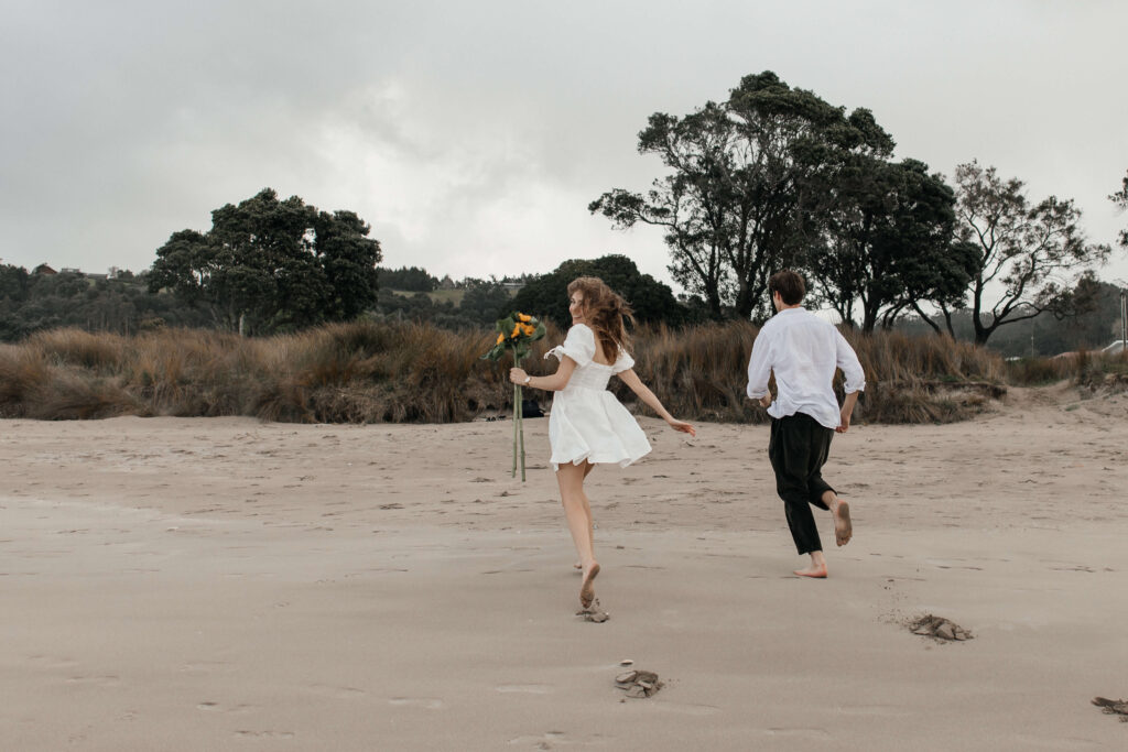 Sunflowers for the engagement photo shoot Candid moments Beach Engagement photo shoot Cooks Beach Surprise Proposal Coromandel Proposal