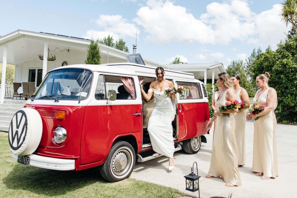 Outdoor Whangamata wedding ceremony with farm backdrop and rolling Coromandel hills.