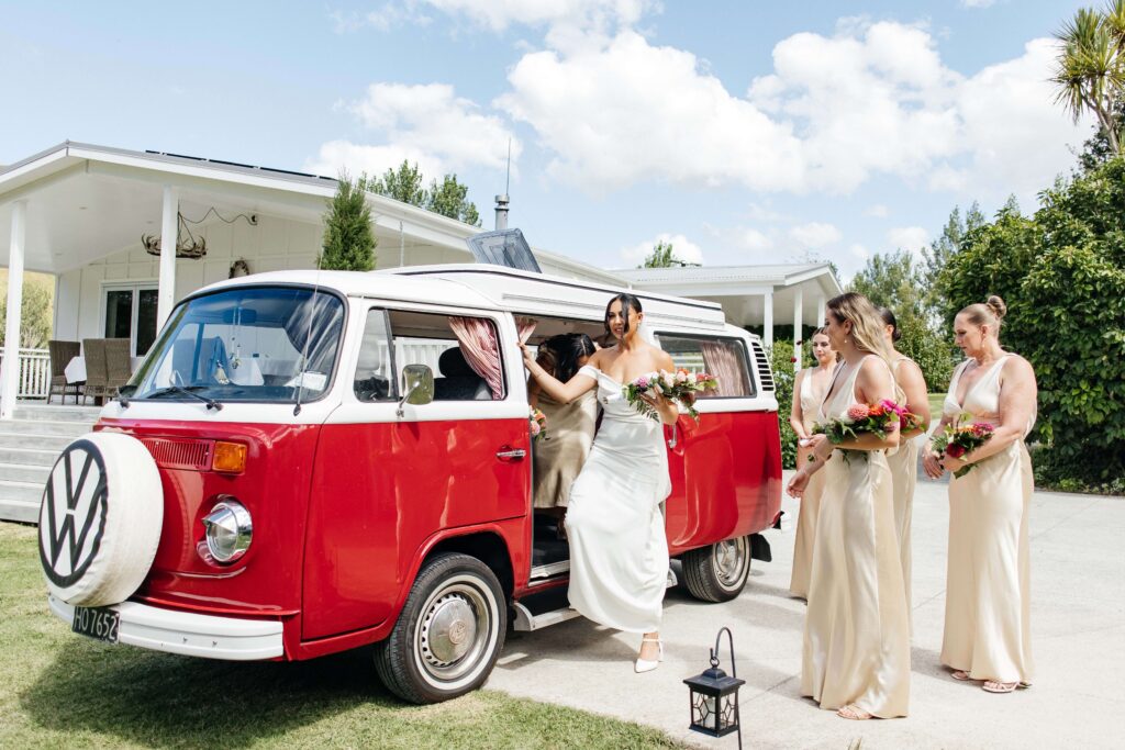 Outdoor Whangamata wedding ceremony with farm backdrop and rolling Coromandel hills.