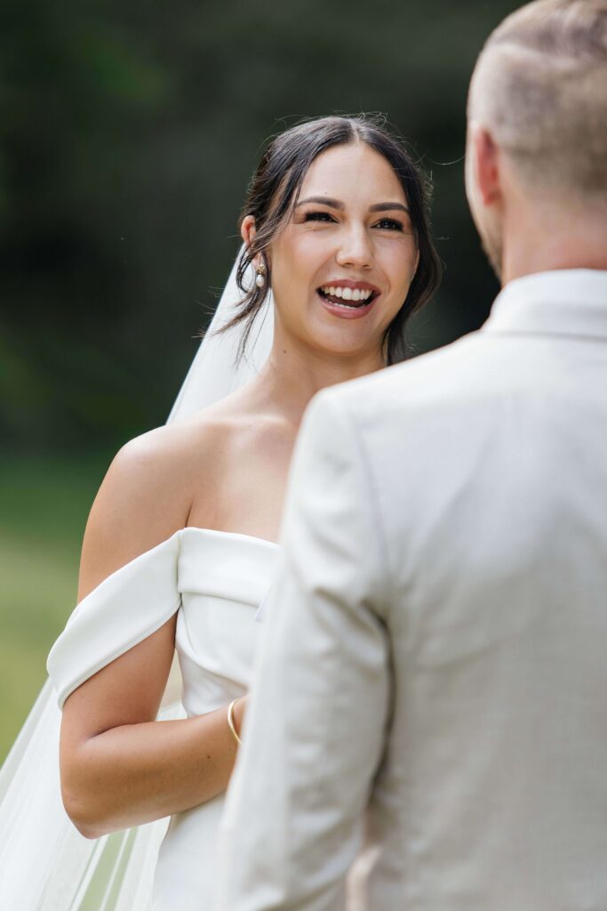 Bride and groom exchanging vows at Whangamata Farm Weddings, rustic ceremony setup for a Whangamata wedding.