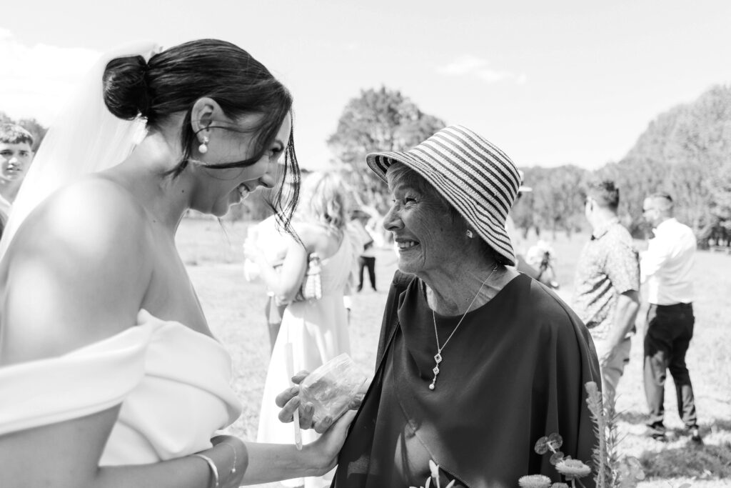 Outdoor Whangamata wedding ceremony with farm backdrop and rolling Coromandel hills.