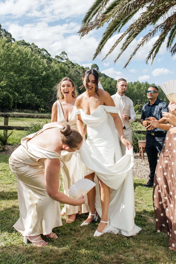 Outdoor Whangamata wedding ceremony with farm backdrop and rolling Coromandel hills.