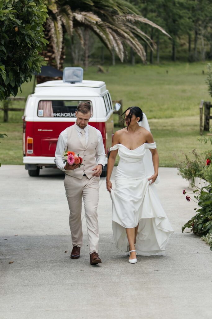 Whangamata wedding couple sharing a quiet moment in the fields of Whangamata Farm Weddings.