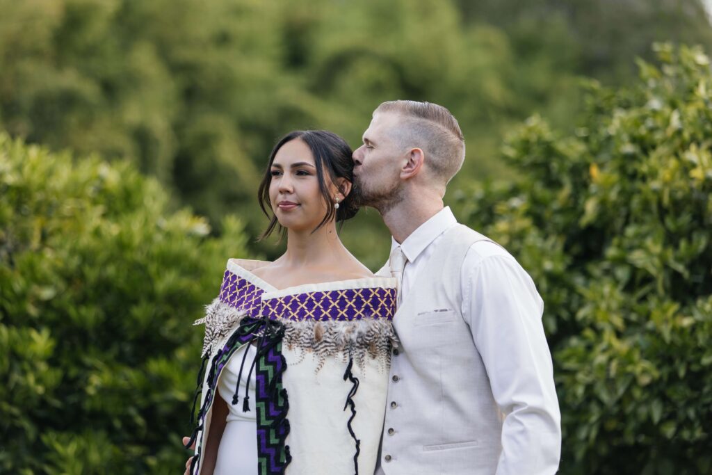 Whangamata wedding couple sharing a quiet moment in the fields of Whangamata Farm Weddings.