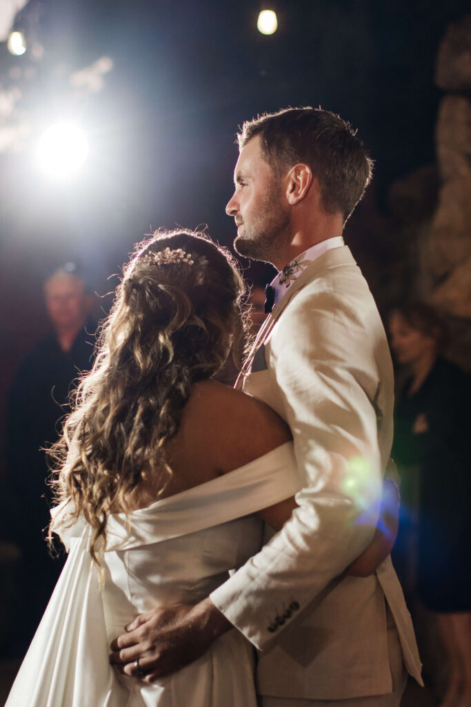 First dance under fairy lights on outdoor dance floor at The Red Barn