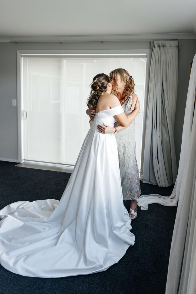 bride puts her dress on 