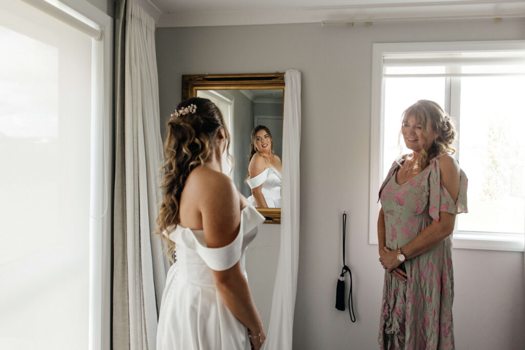 bride puts her dress on 