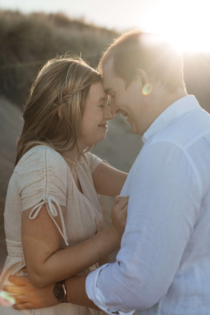 Candid couple laughing together at Hot Water Beach Coromandel