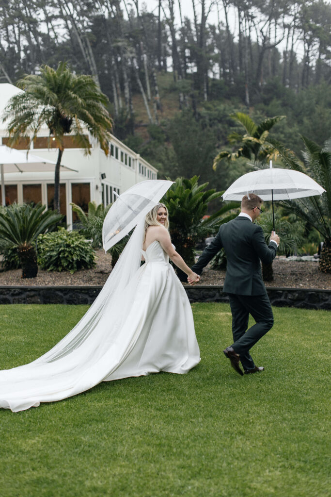 Bride and Groom walking through Puketutu Island Estate gardens