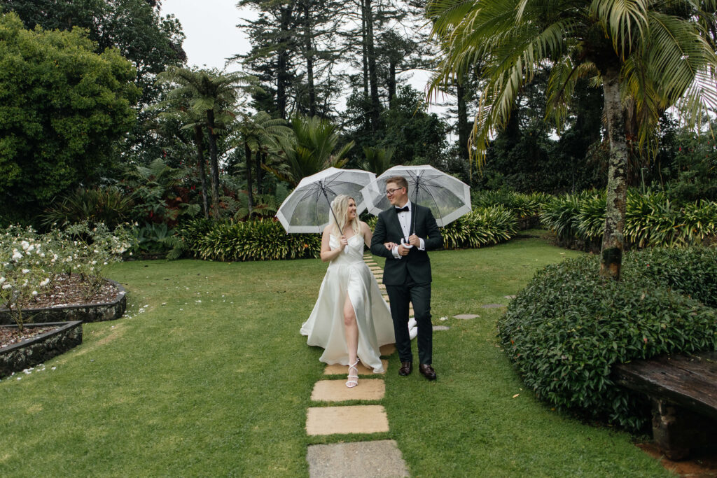 Bride and Groom walking through Puketutu Island Estate gardens
