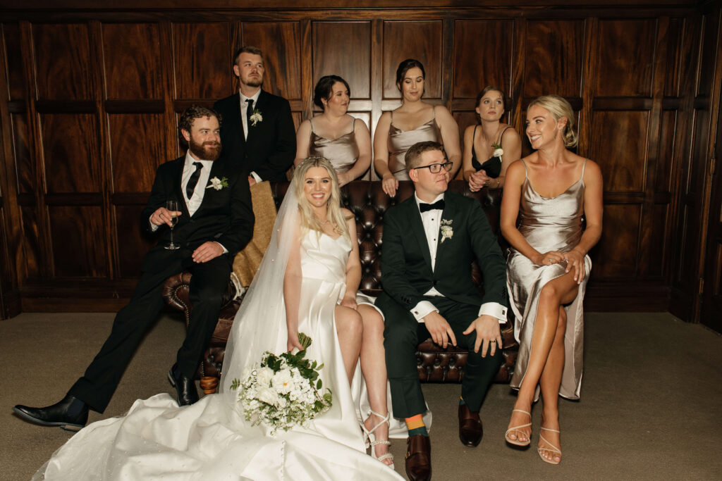 Elegant bridal party portrait inside Puketutu Island Estate Spanish Mansion room
