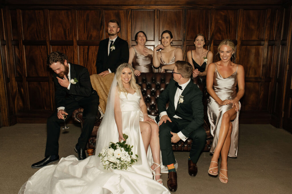 Elegant bridal party portrait inside Puketutu Island Estate Spanish Mansion room