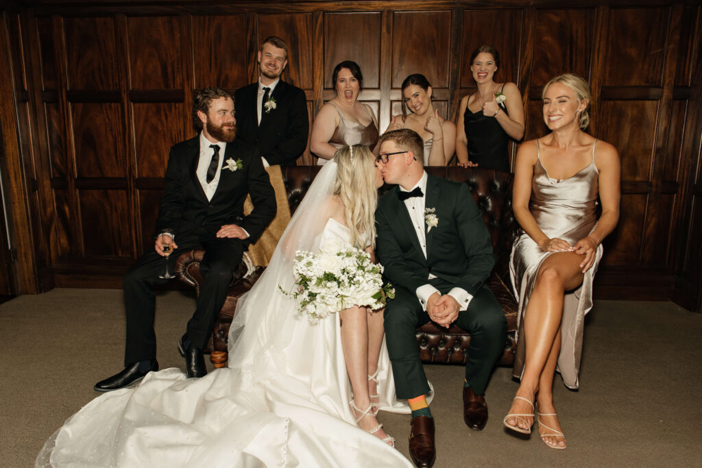 Elegant bridal party portrait inside Puketutu Island Estate Spanish Mansion room