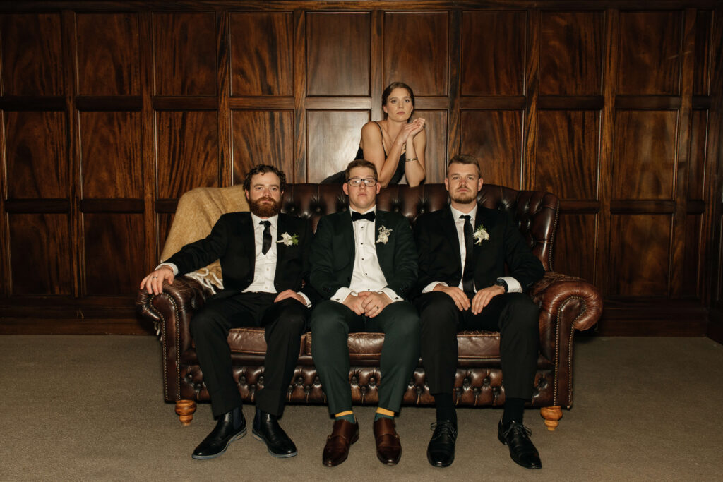 Elegant bridal party portrait inside Puketutu Island Estate Spanish Mansion room