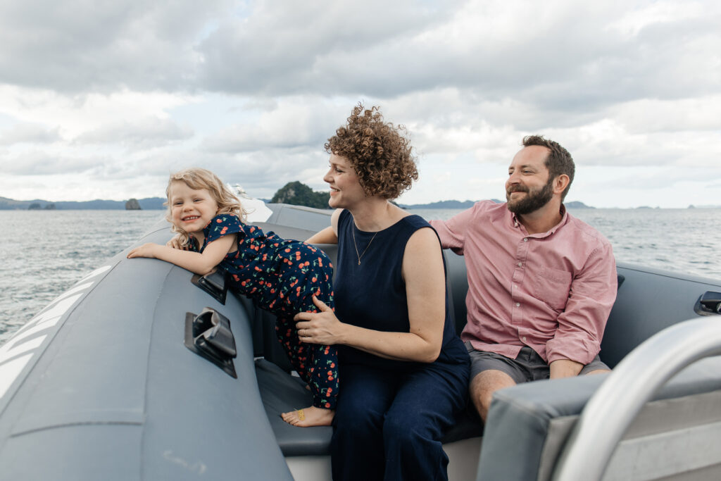 Family arriving at Cathedral Cove by private water taxi – Coromandel photography session