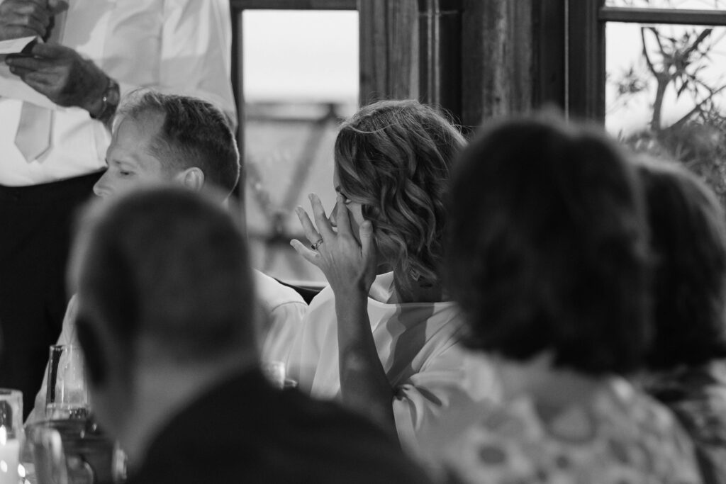 Guests laughing and sharing speeches during wedding reception at Mudbrick – Waiheke Island vineyard wedding