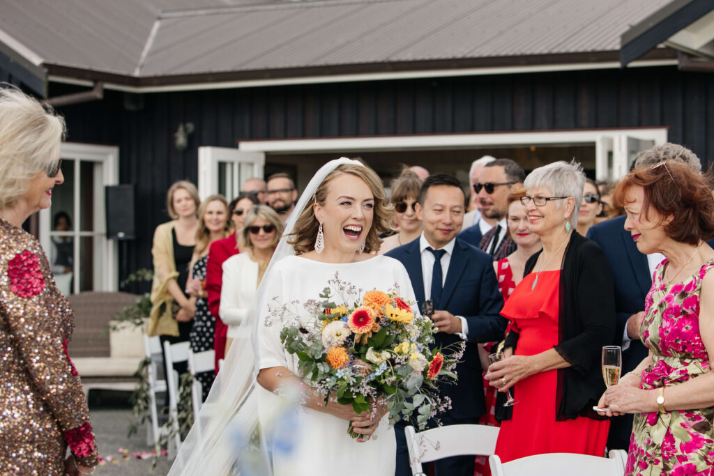 Bride is walking down the aisle at Mudbrick