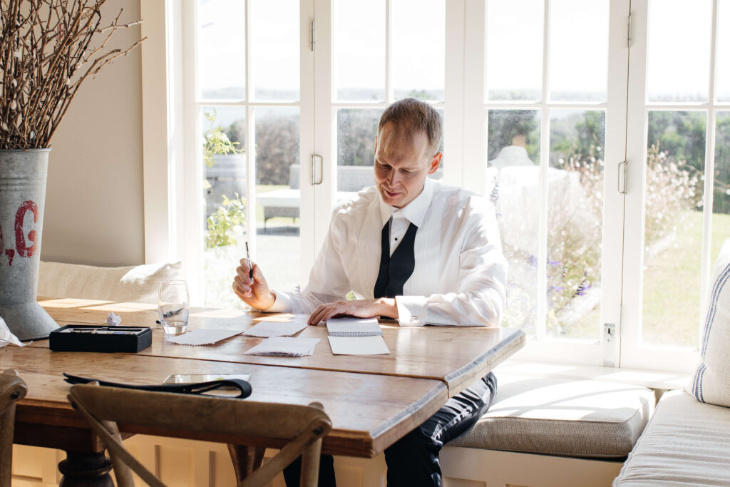 Groom writing his vows before the ceremony