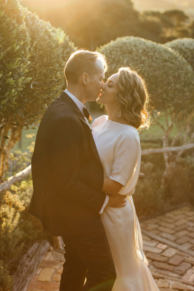 Bride and groom portraits in vineyard during golden hour – autumn wedding at Mudbrick Waiheke Island