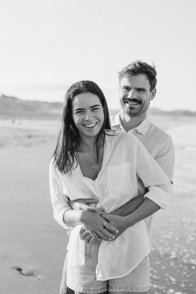 Couple laughing together during engagement photography session on Coromandel Peninsula – Coromandel engagement photographer