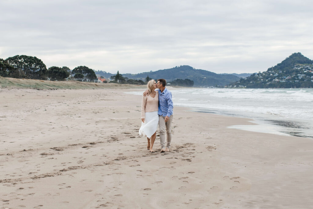 a couple walking on Pauanui beach
