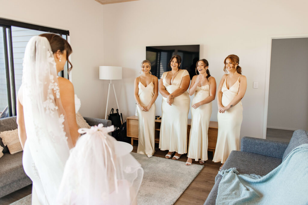 First look with the bridesmaids at Castaways Resort in Waiuku
