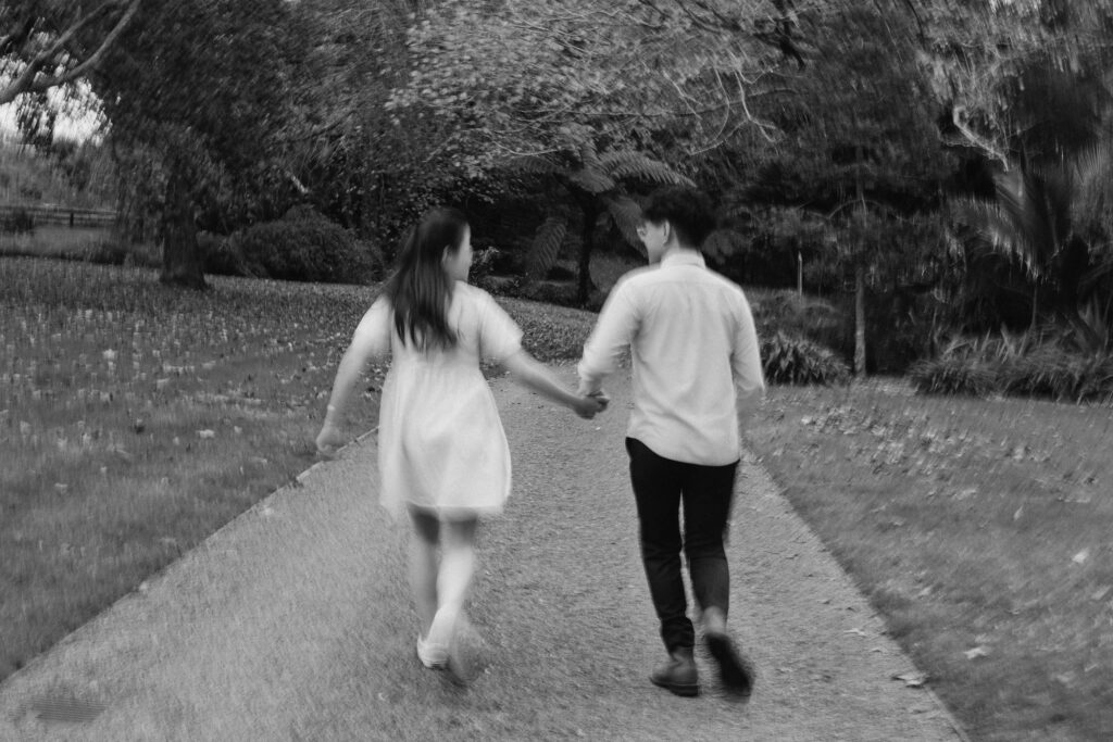 Engaged couple walking through Ayrlies Garden Auckland