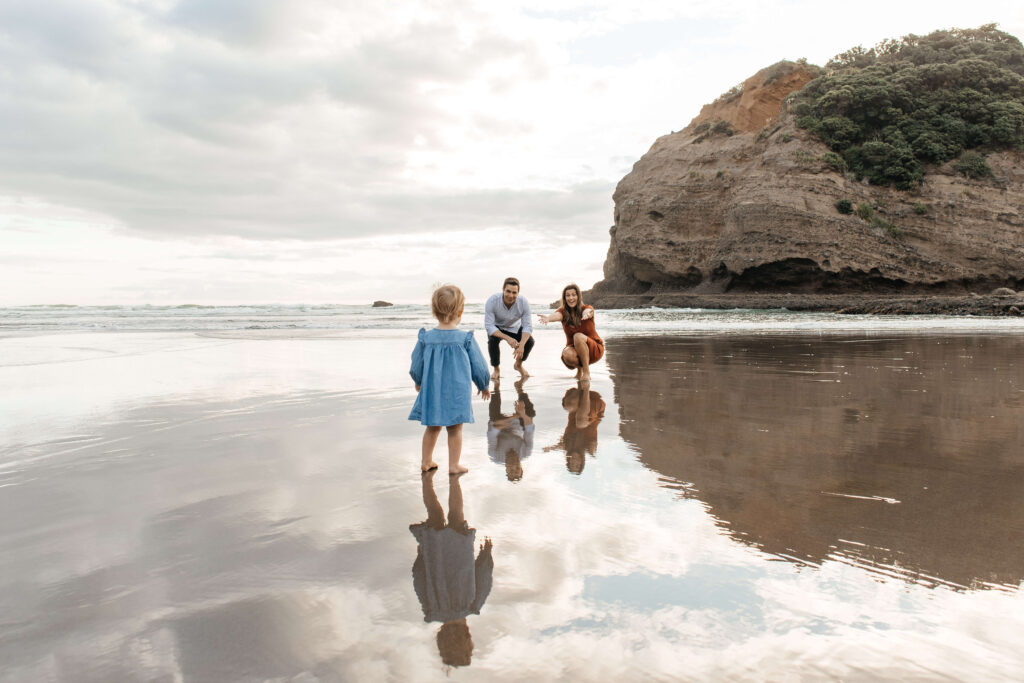 Candid moment between parents and child at sunset