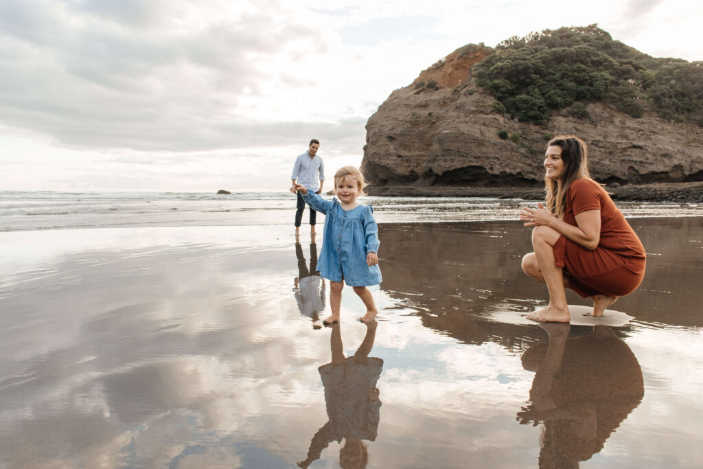 Candid moment between parents and child at sunset