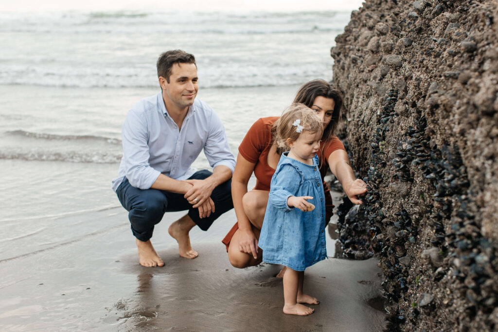 Candid moment between parents and child at sunset