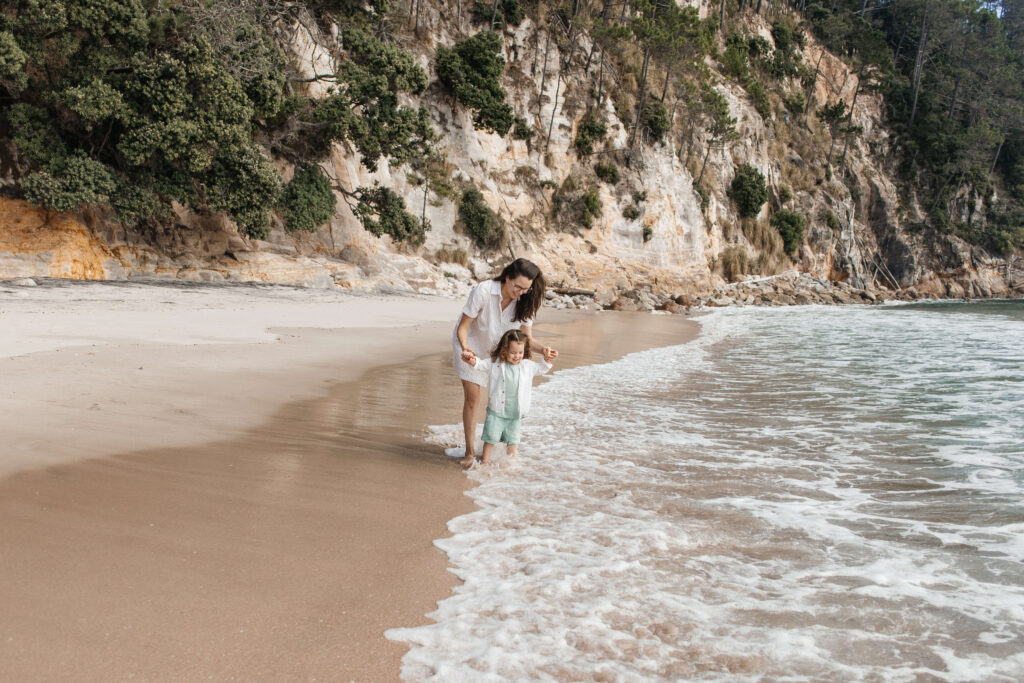 Scenic Hahei Beach backdrop during overseas family photography session