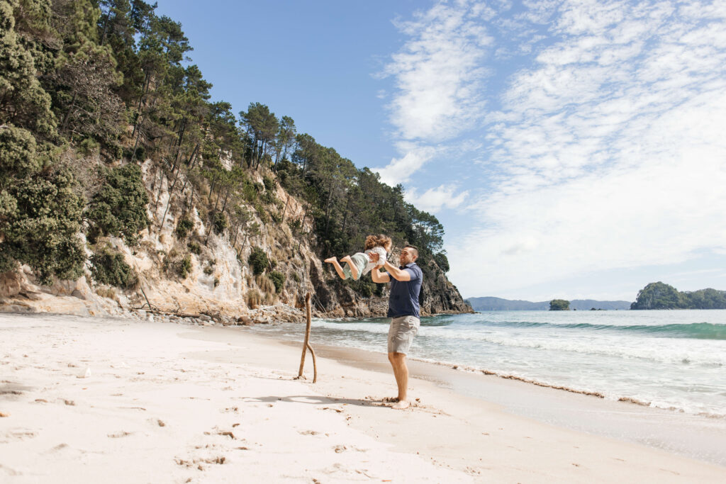 Scenic Hahei Beach backdrop during overseas family photography session