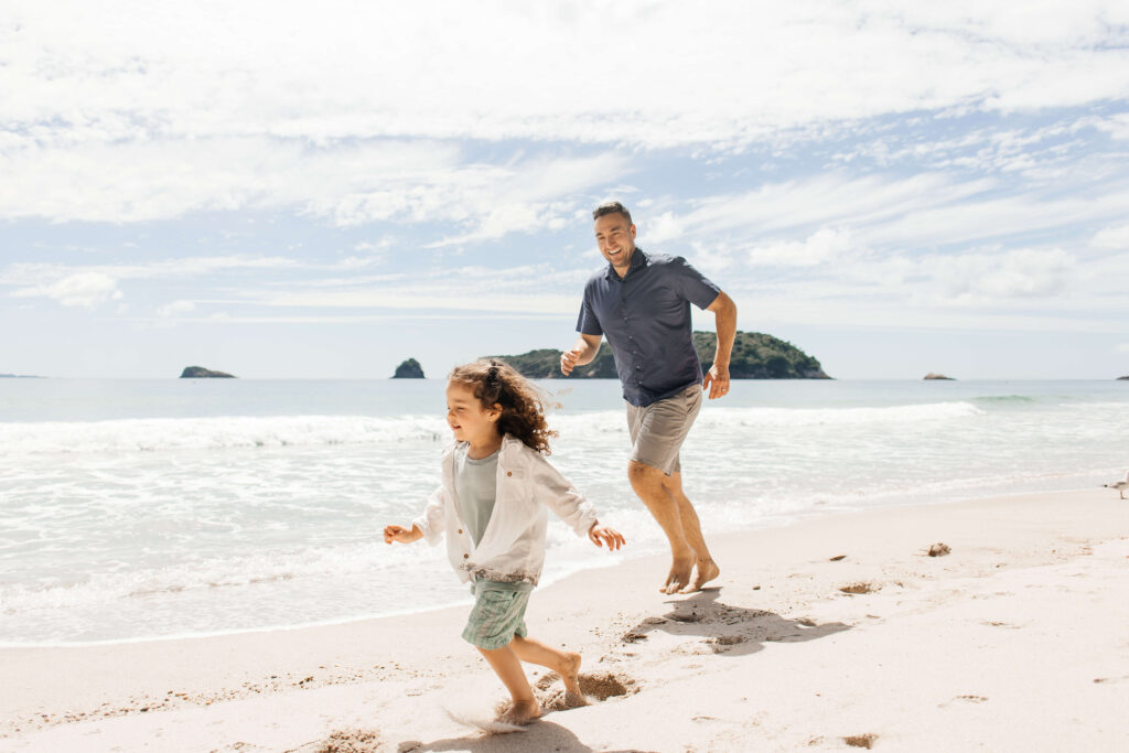 Scenic Hahei Beach backdrop during overseas family photography session