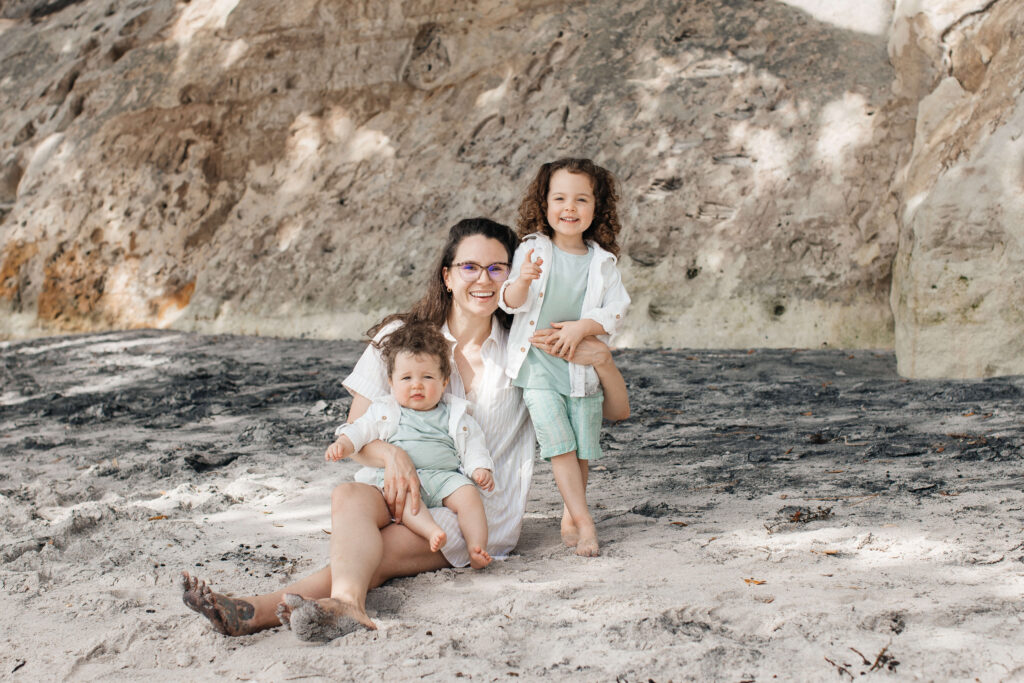 Candid family moment at Hahei Beach with kids laughing and playing