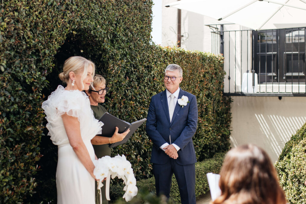 Angela and David’s intimate ceremony at PAX Venue Auckland wedding with elegant floral arrangements