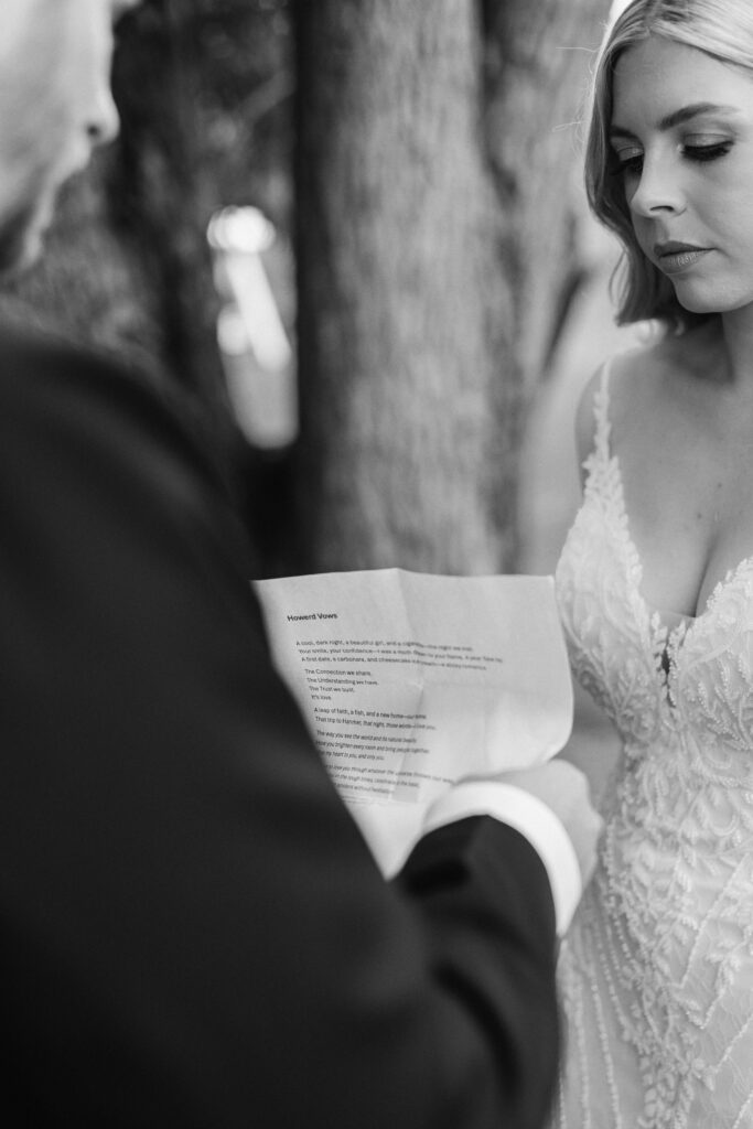 Shay and Howerd sharing private vows in the gardens at Abel Estate, captured candidly by their Auckland wedding photographer.
