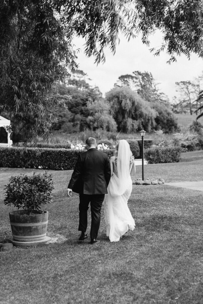 Bride and groom sharing a private first look in the gardens of Abel Estate before their Auckland wedding ceremony.