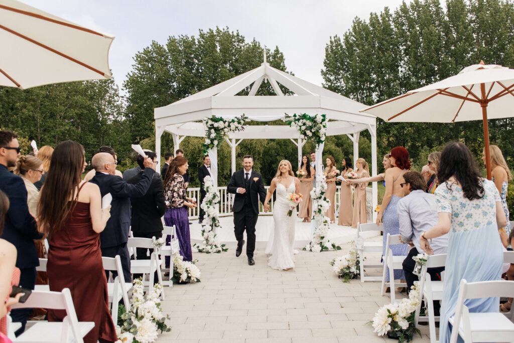 Beautifully styled ceremony setup at Abel Estate in Kumeū with floral arrangements and garden views.