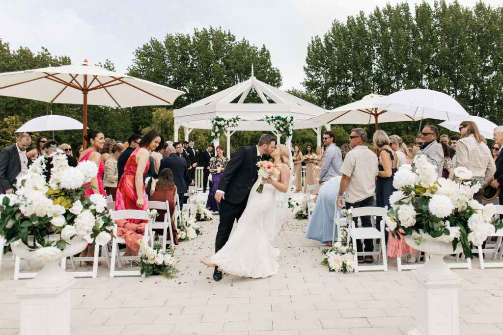 Beautifully styled ceremony setup at Abel Estate in Kumeū with floral arrangements and garden views.
