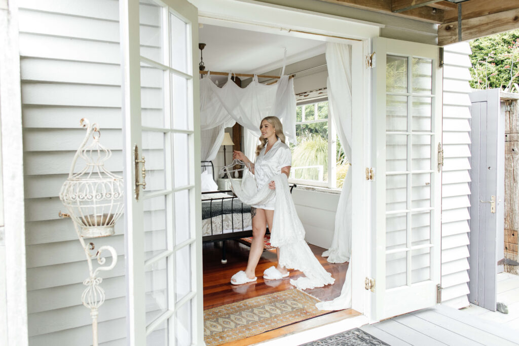 Shay getting ready with her bridesmaids and mum at Honeysuckle Cottage, a romantic bush cottage in Auckland before her Abel Estate wedding.