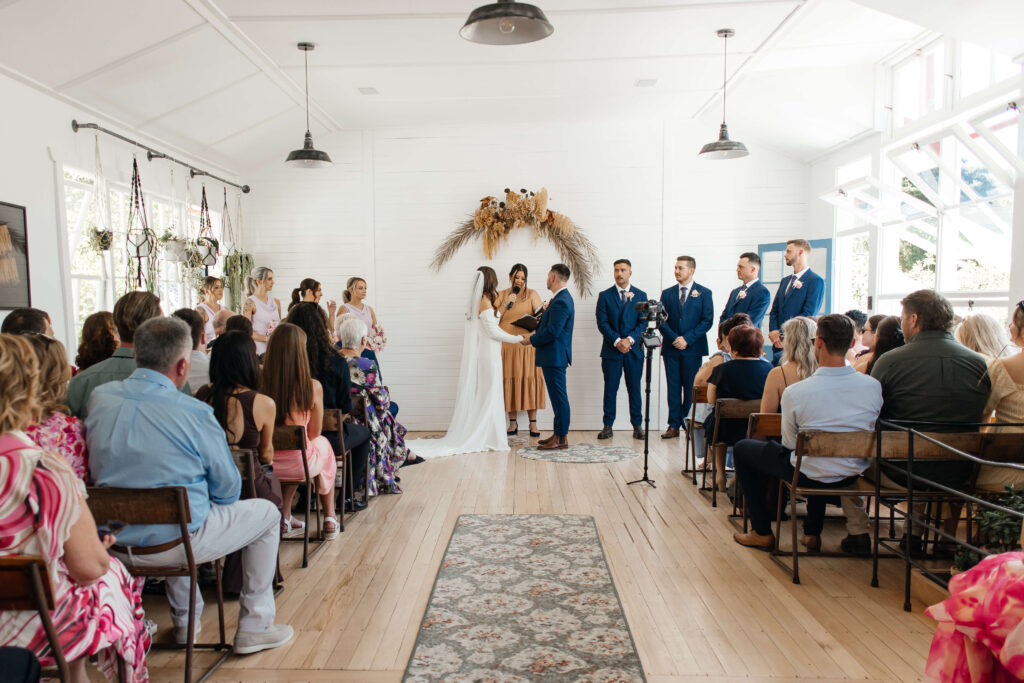 Couple exchanging vows inside Old Forest School house wedding ceremony venue.