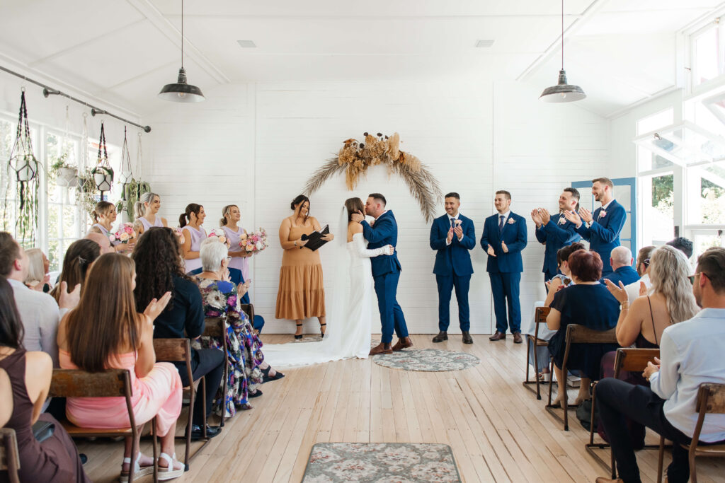 Couple exchanging vows inside Old Forest School house wedding ceremony venue.
