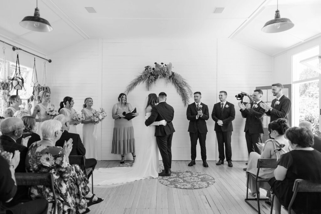 Couple exchanging vows inside Old Forest School house wedding ceremony venue.
