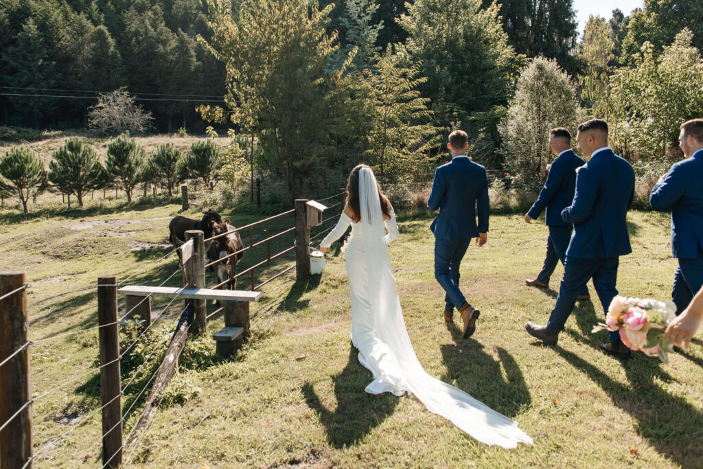Bridal party celebrating with donkeys during Old Forest School wedding photos.