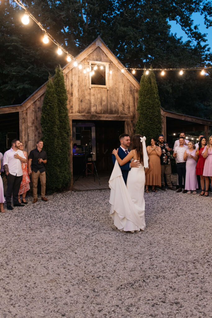 First Dance under festoon lights at Old Forest School wedding reception.