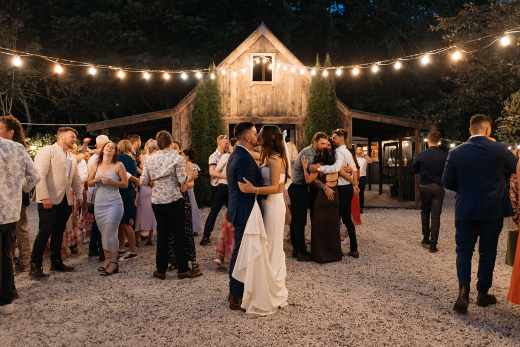 First Dance under festoon lights at Old Forest School wedding reception.