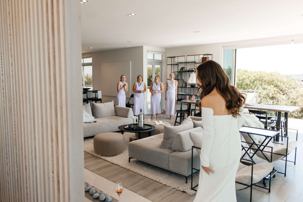 Bride getting ready for her Old Forest School wedding at beachfront accommodation in Pukehina.
