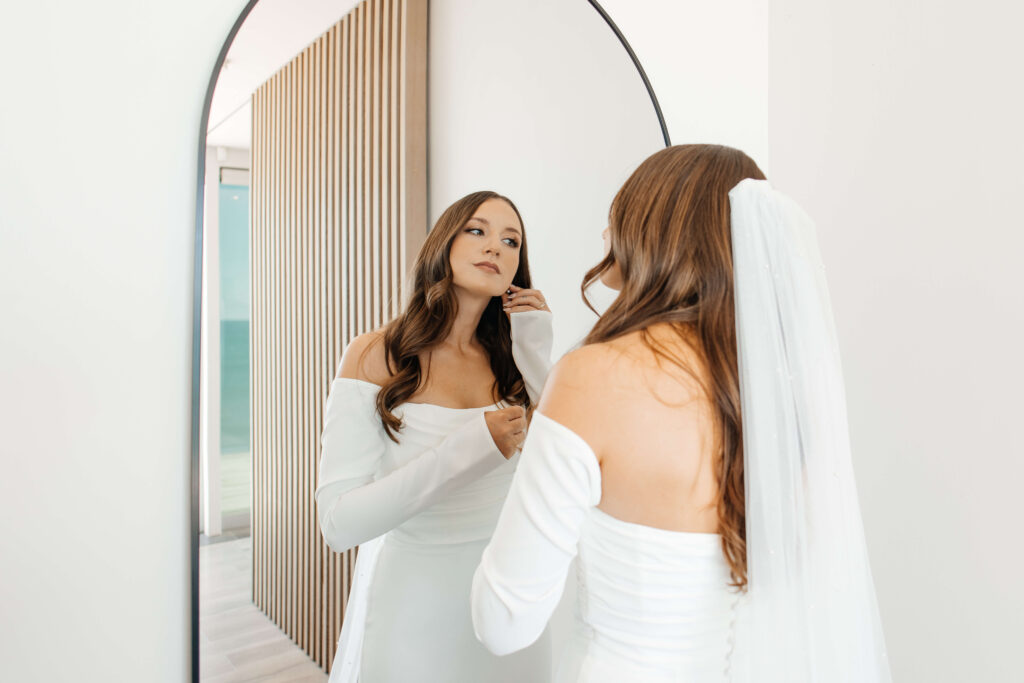 Bride getting ready for her Old Forest School wedding at beachfront accommodation in Pukehina.