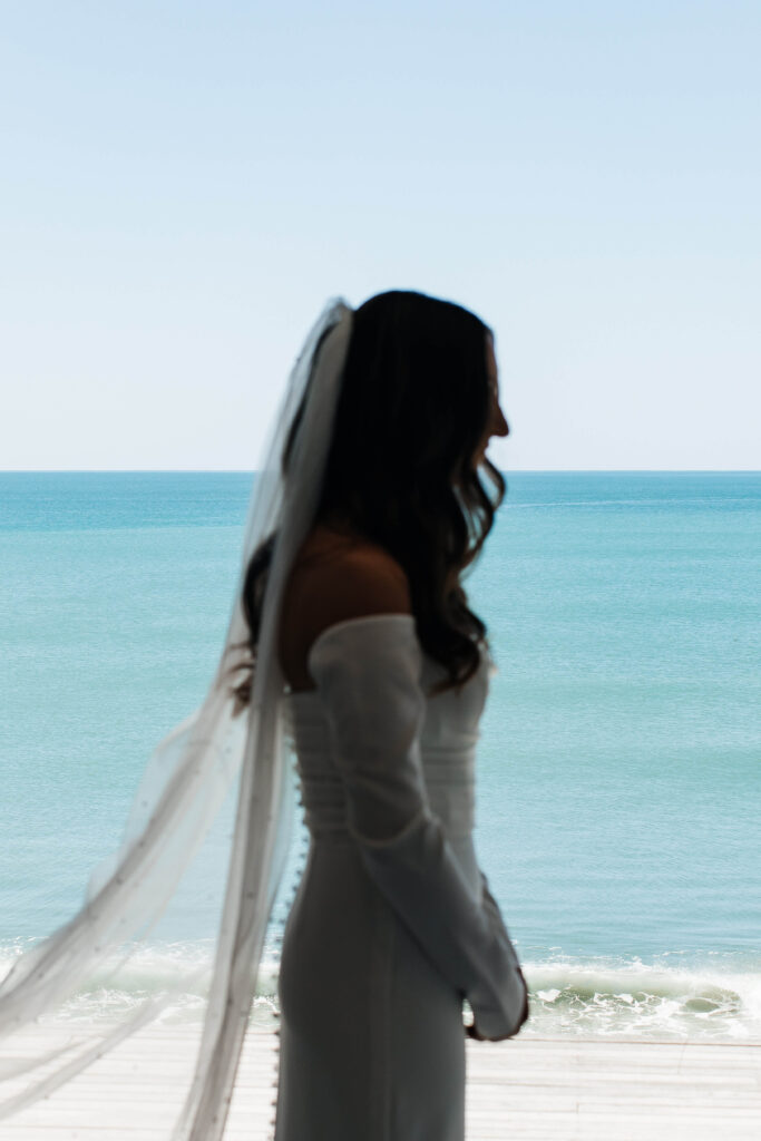 Bride getting ready for her Old Forest School wedding at beachfront accommodation in Pukehina.