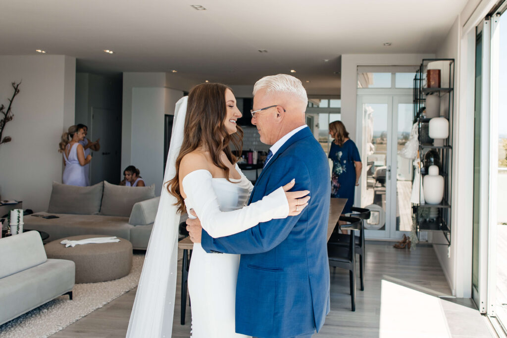 Bride shares emotional first look with father before Old Forest School wedding ceremony.
